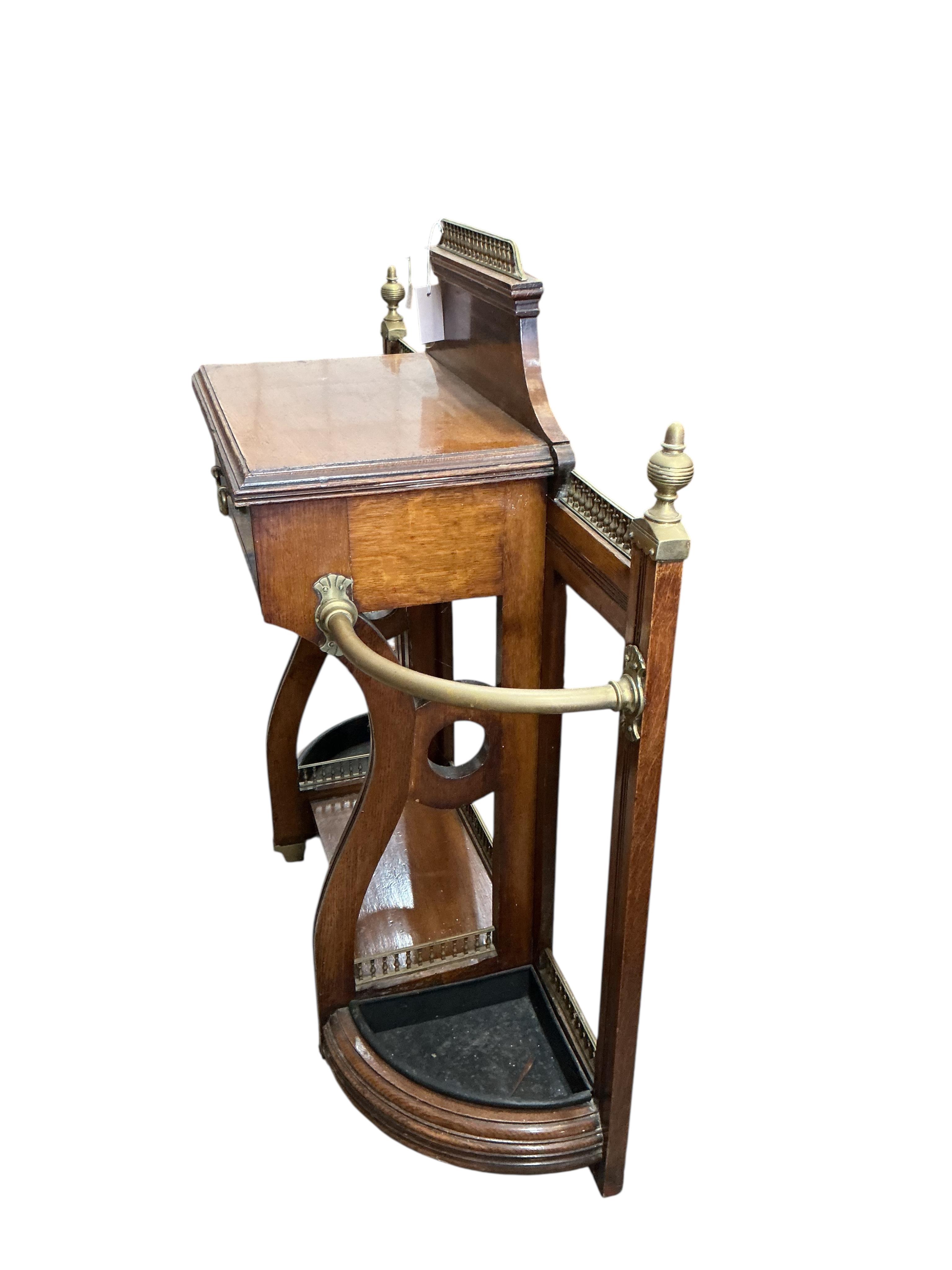 A late Victorian brass mounted oak low hallstand, width 102cm, depth 35cm, height 100cm